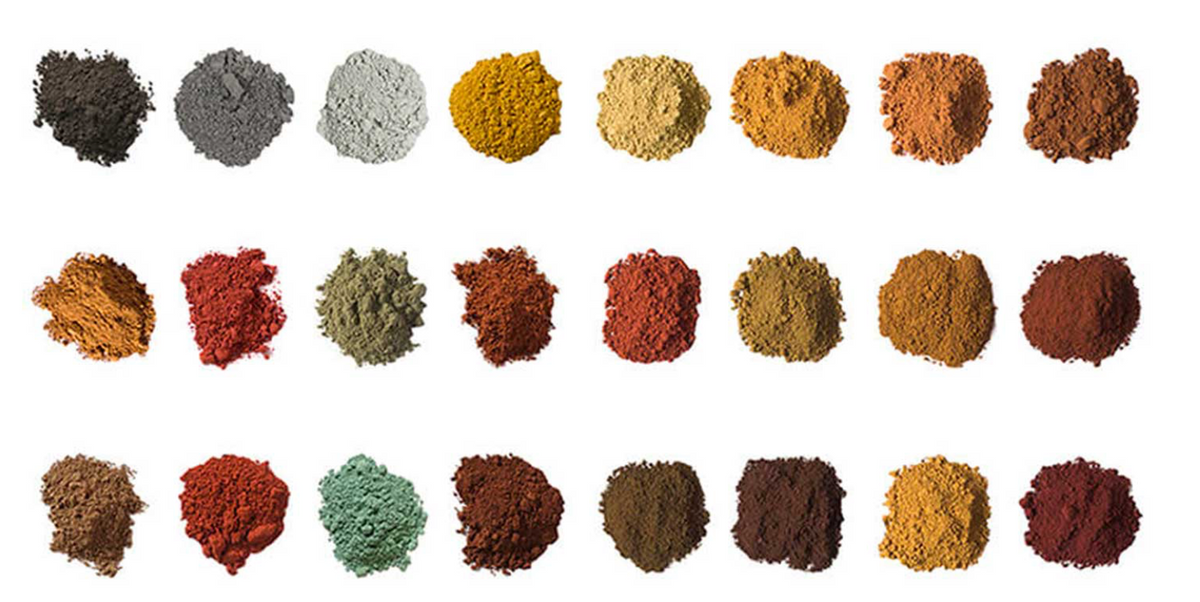 Natural botanical powders in earthy tones, arranged in neat rows