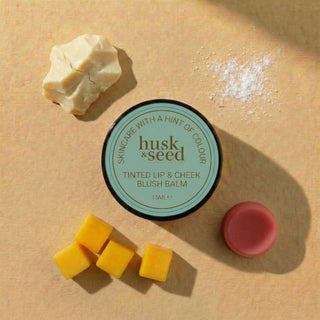 Coral Lip & Cheek Balm lid with a coral swatch, mango and illipe butter